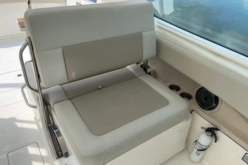 Slide: The Image of 2021 Boston Whaler 280 Vantage boat seat with cup holders and fire extinguisher. - 12
