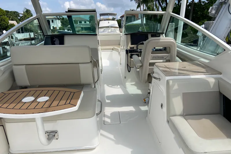 Slide: The Image of 2021 Boston Whaler 280 Vantage interior with seating and helm, showcasing luxury design. - 15