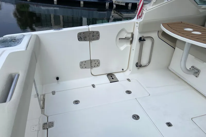 Slide: The Image of 2021 Boston Whaler 280 Vantage boat interior with seating and table. - 16