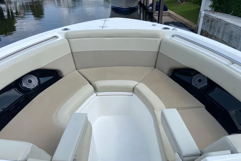 Slide: The Image of 2021 Boston Whaler 280 Vantage boat interior with beige seating and speakers. - 17
