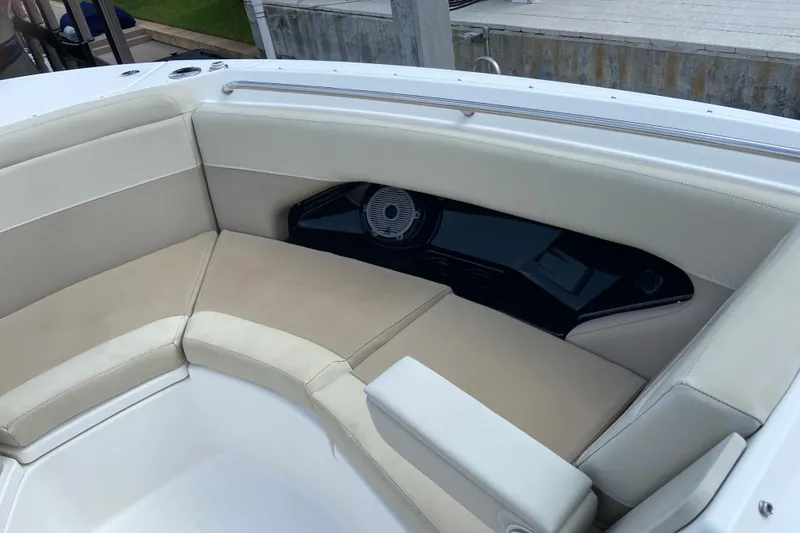 Slide: The Image of 2021 Boston Whaler 280 Vantage boat interior with beige seating and speaker system. - 18