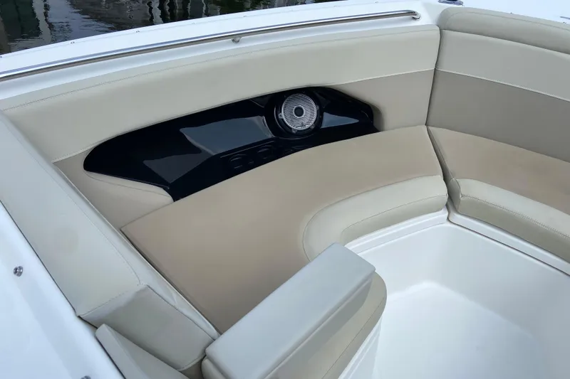 Slide: The Image of 2021 Boston Whaler 280 Vantage boat interior with beige seating and speaker. - 19