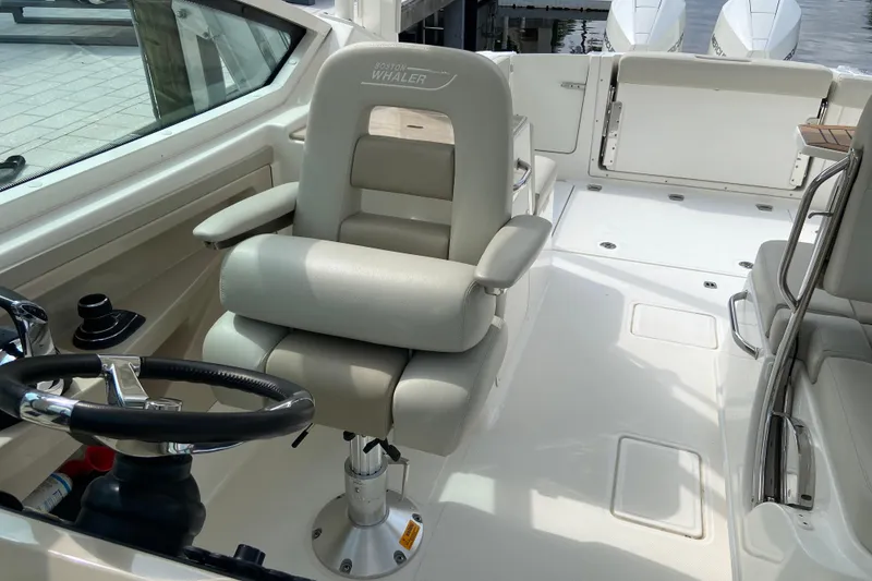 Slide: The Image of 2021 Boston Whaler 280 Vantage cockpit with steering wheel and seating. - 22