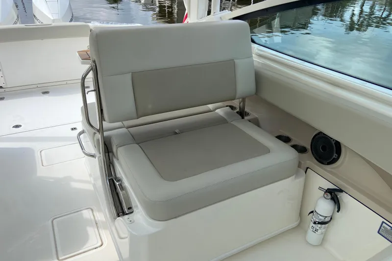 Slide: The Image of 2021 Boston Whaler 280 Vantage boat interior with cushioned seating and safety equipment. - 23