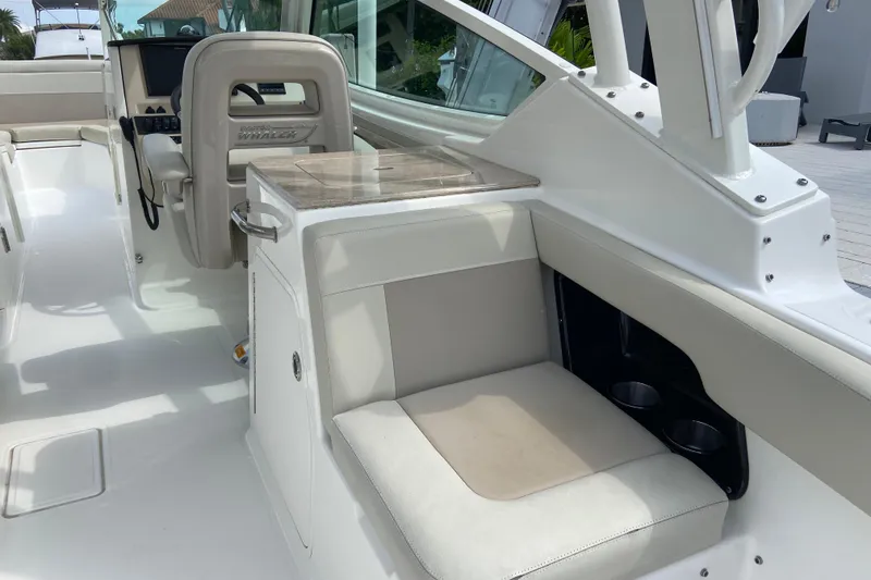 Slide: The Image of 2021 Boston Whaler 280 Vantage interior with seating and helm station. - 26