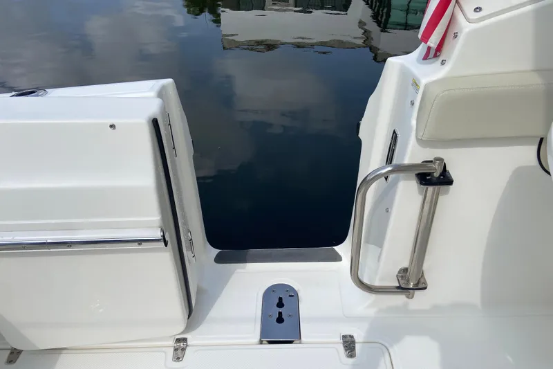 Slide: The Image of 2021 Boston Whaler 280 Vantage boat entryway with stainless steel railing and water view. - 27