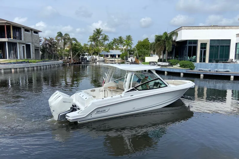 Slide: The Image of 2021 Boston Whaler 280 Vantage boat cruising in a scenic canal setting. - 3