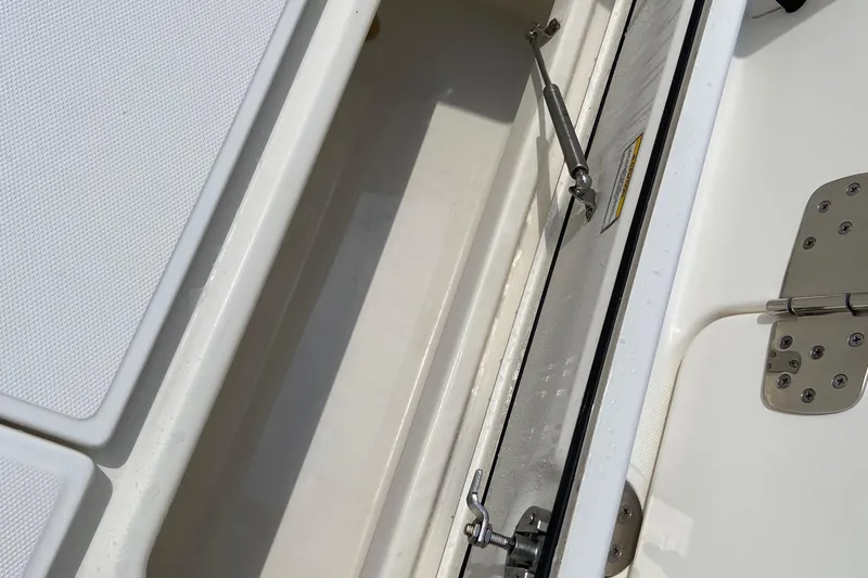 Slide: The Image of 2021 Boston Whaler 280 Vantage storage compartment with stainless steel hinges and latch. - 31