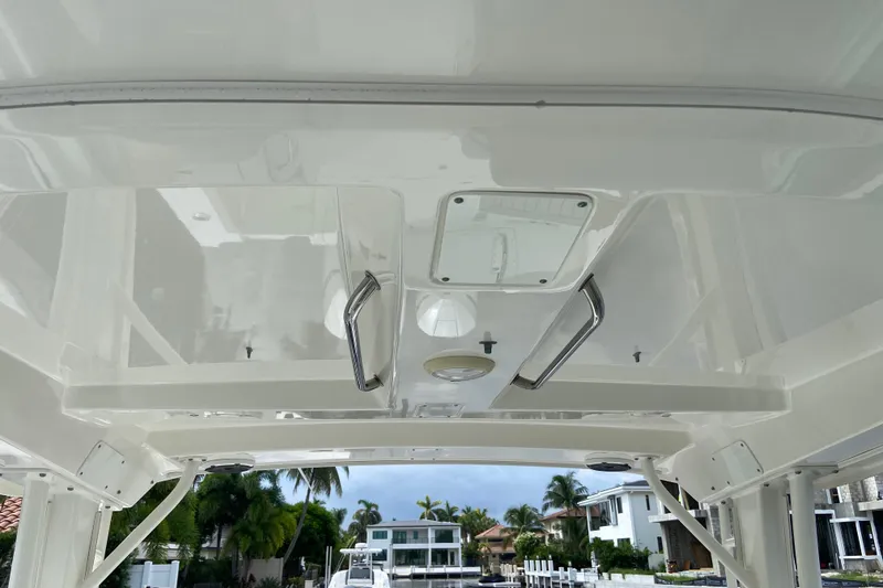 Slide: The Image of 2021 Boston Whaler 280 Vantage boat interior ceiling with handles and hatch. - 36