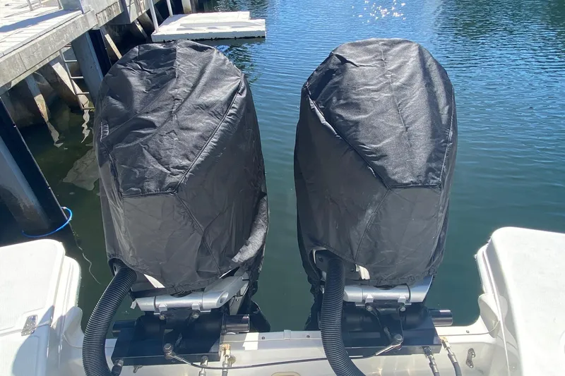 Slide: The Image of Covered outboard motors on a 2021 Boston Whaler 280 Vantage boat at a dock. - 42