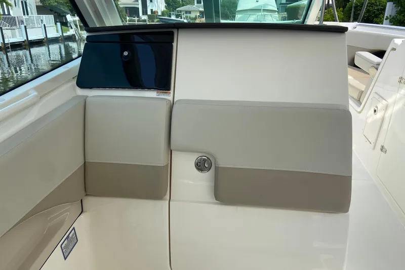 Slide: The Image of 2021 Boston Whaler 280 Vantage interior detail with beige and white seating. - 8