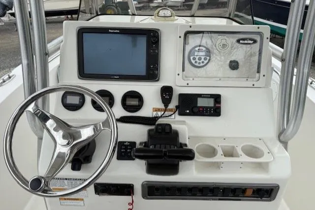 Slide: The Image of 2013 NauticStar 2500XS Offshore boat dashboard with steering wheel and navigation controls. - 5