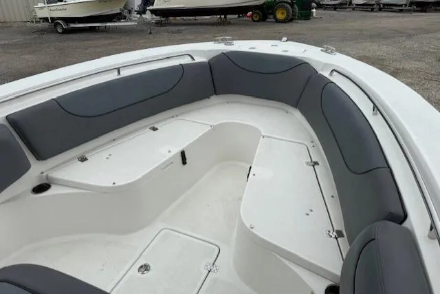 Slide: The Image of 2013 NauticStar 2500XS Offshore boat interior with gray seating and storage compartments. - 8