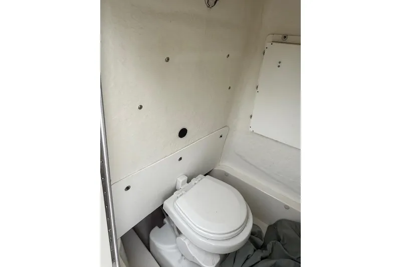 Slide: The Image of 2013 NauticStar 2500XS Offshore boat interior with compact marine toilet. - 9