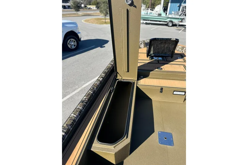 Slide: The Image of 2026 Avid 18 Commander boat interior with storage compartment and control panel. - 13