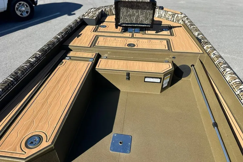 Slide: The Image of 2026 Avid 18 Commander boat interior with wood accents and camouflage trim. - 16