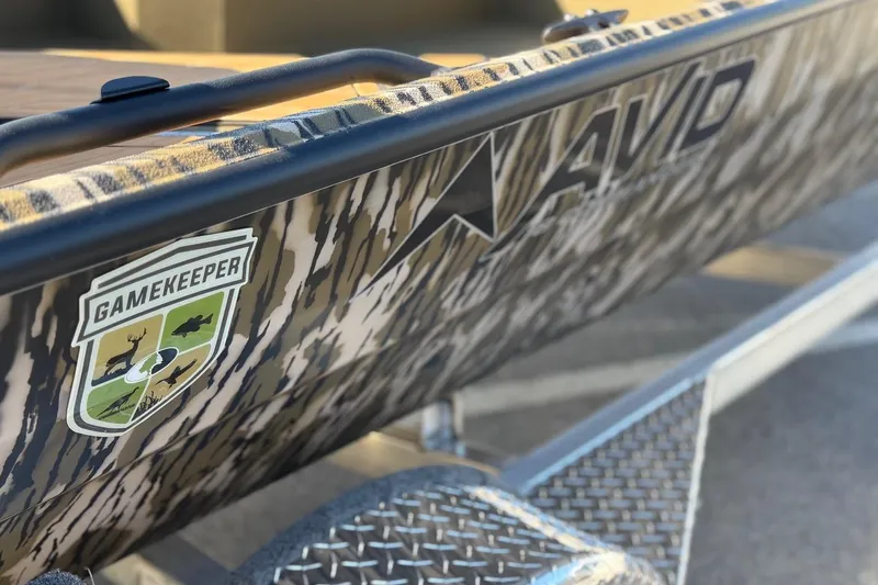 Slide: The Image of 2026 Avid 18 Commander boat with camo design and Gamekeeper logo. - 7