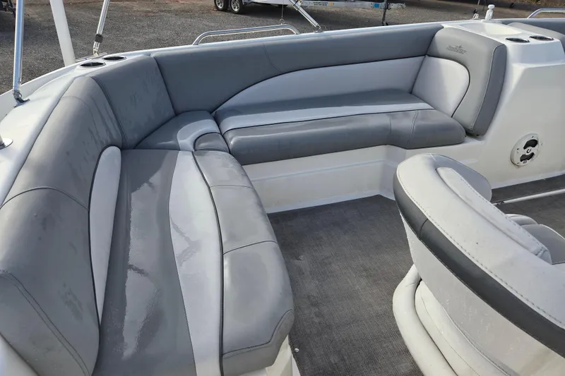 Slide: The Image of 2022 NauticStar 193 SC boat interior with gray seating and cup holders. - 11