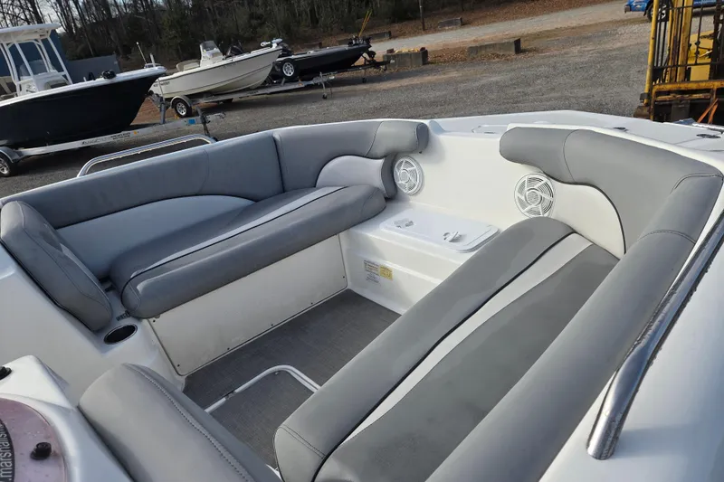 Slide: The Image of 2022 NauticStar 193 SC boat interior with gray seating and speakers. - 14