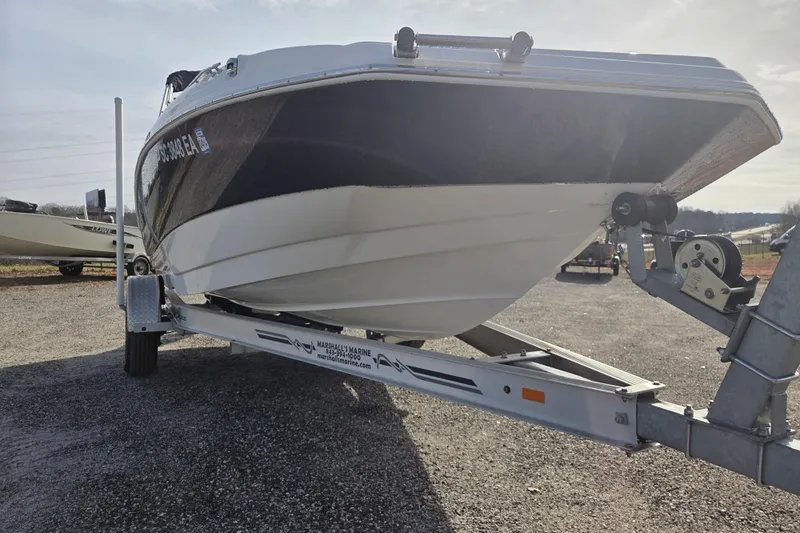 Slide: The Image of 2022 NauticStar 193 SC boat on trailer, parked outdoors. - 2