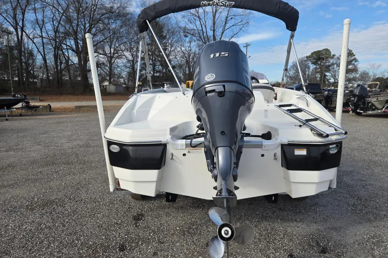 Slide: The Image of 2022 NauticStar 193 SC boat with Yamaha 115 engine, parked outdoors. - 5
