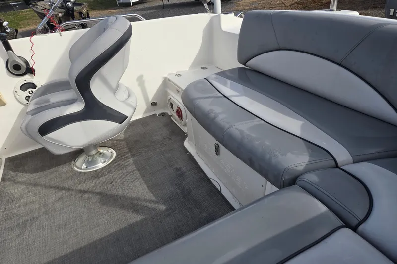 Slide: The Image of 2022 NauticStar 193 SC boat interior with gray seating and carpeted floor. - 7
