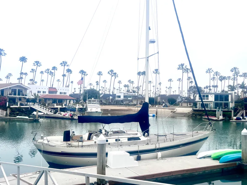 The Image of Sailboat docked in a marina with palm trees, Lafitte 44, 1980 model. - 0