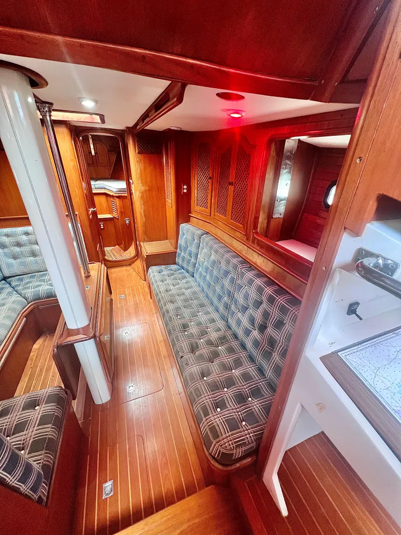 Slide: The Image of Interior of 1980 Lafitte 44 sailboat with wood paneling and plaid seating. - 23