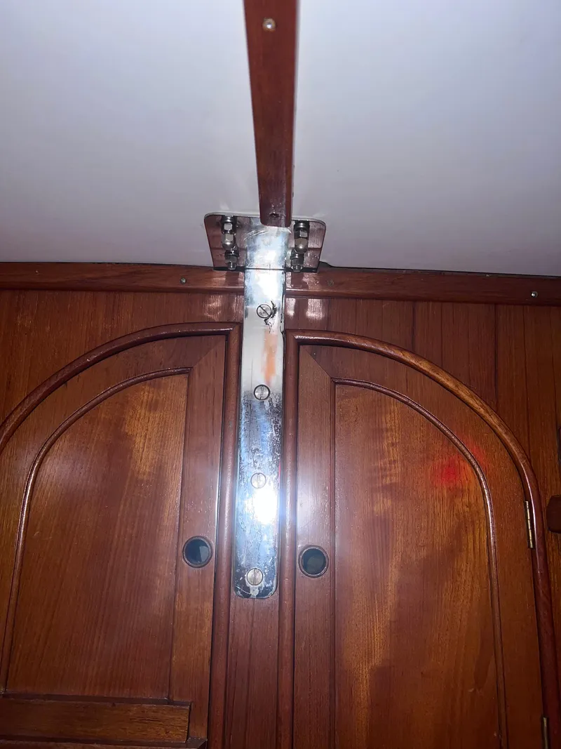 Slide: The Image of Wooden interior of a 1980 Lafitte 44 sailboat, featuring polished metal fittings. - 30