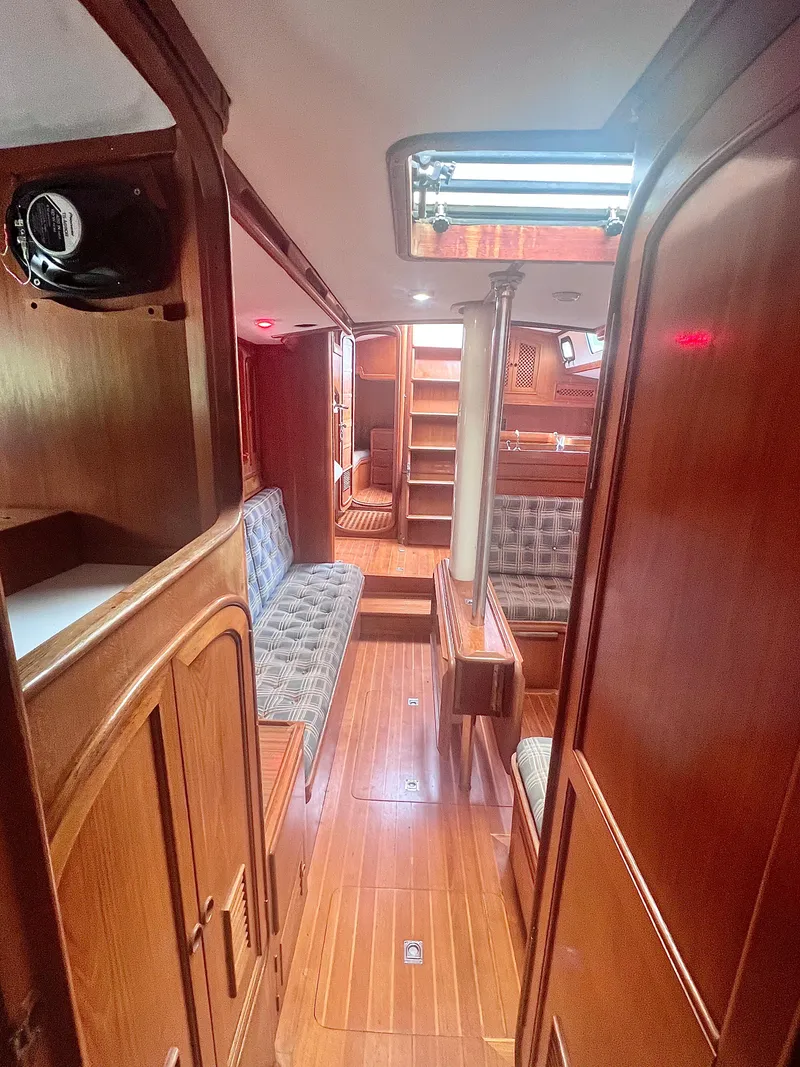 Slide: The Image of Interior of a 1980 Lafitte 44 sailboat with wooden furnishings and seating area. - 31