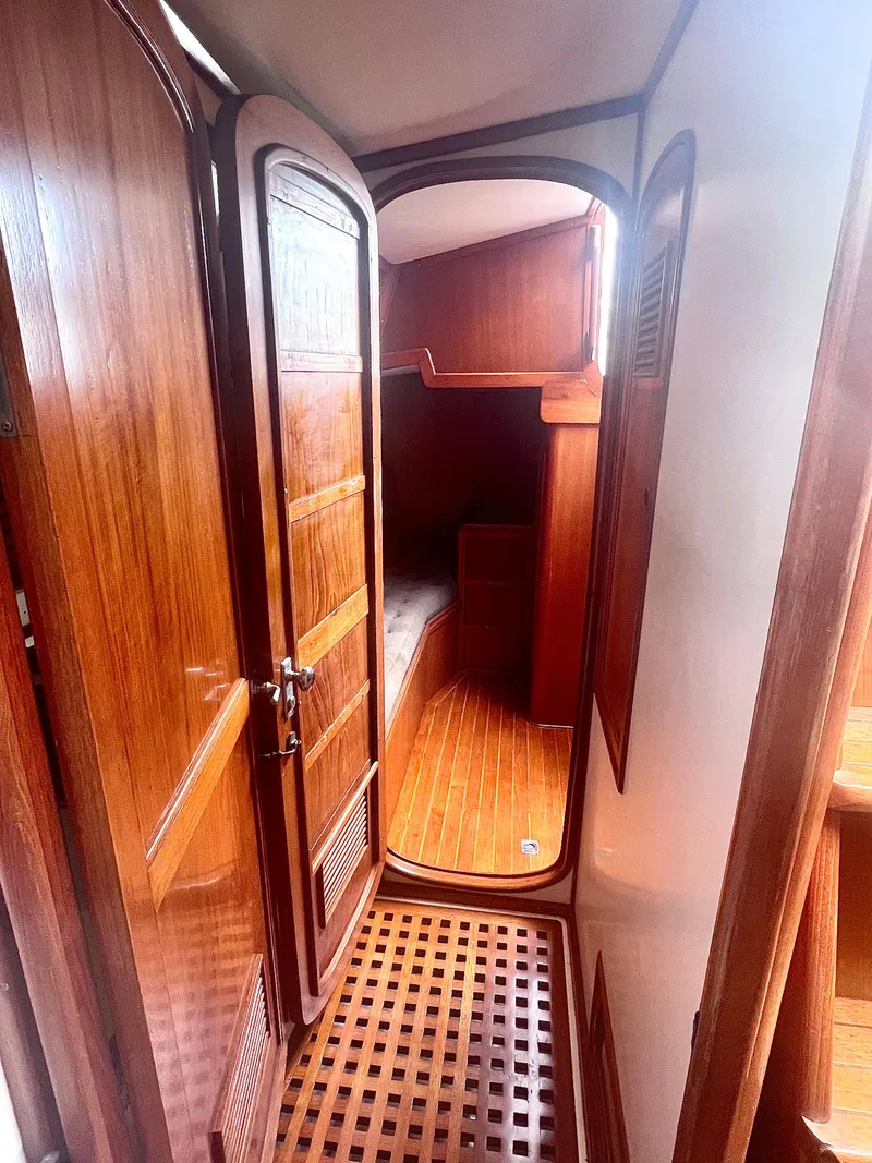 Slide: The Image of 1980 Lafitte 44 yacht interior with wooden paneling and cozy cabin space. - 34
