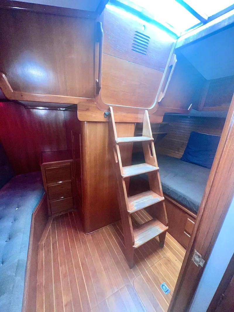 Slide: The Image of Interior of 1980 Lafitte 44 sailboat with wooden ladder and cozy cabin space. - 37