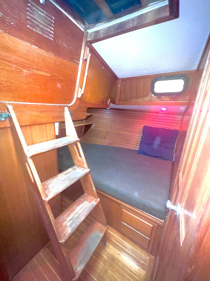 Slide: The Image of Cozy cabin interior of 1980 Lafitte 44 sailboat with wooden ladder and bedding. - 38