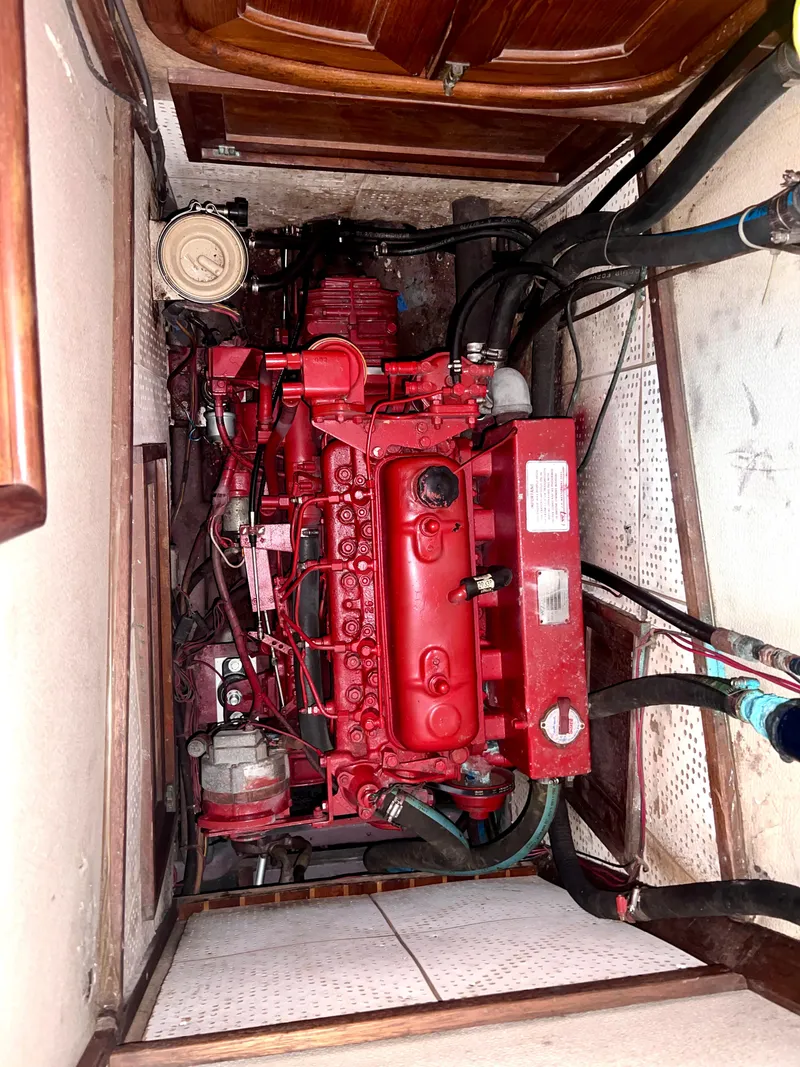 Slide: The Image of Engine room of a 1980 Lafitte 44 sailboat with a red engine. - 41