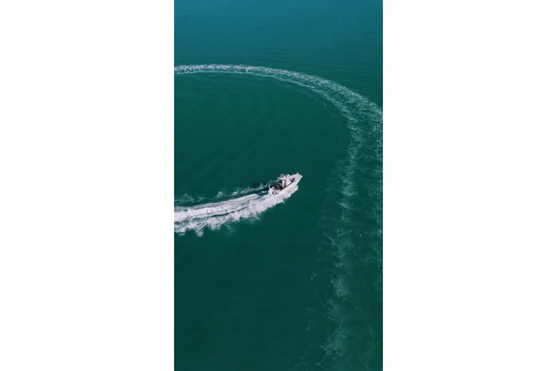 Slide: The Image of Aerial view of Broadwater Boatworks 25 Bay Cat on the water. - 15