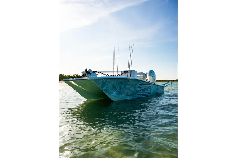 Slide: The Image of 2026 Broadwater Boatworks 25 Bay Cat on serene water under clear sky. - 25
