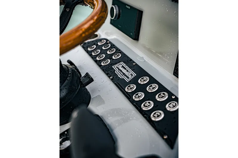 Slide: The Image of Close-up of 2026 Broadwater Boatworks 25 Bay Cat control panel with raindrops. - 27