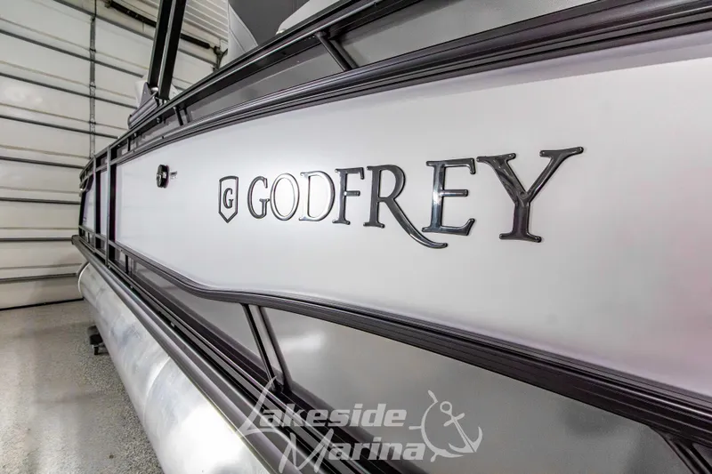 Slide: The Image of 2026 Godfrey Monaco 235 QSB pontoon boat in a marina showroom. - 10