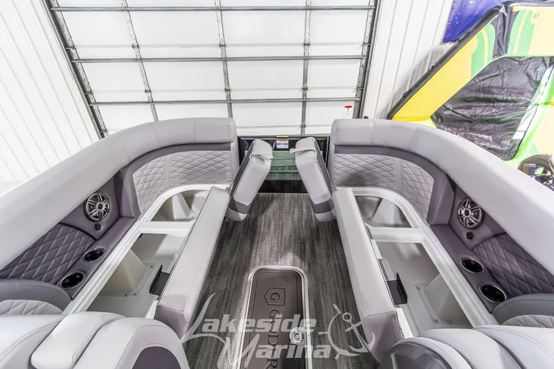 Slide: The Image of Interior of 2026 Godfrey Monaco 235 QSB pontoon boat with luxurious seating and speakers. - 19