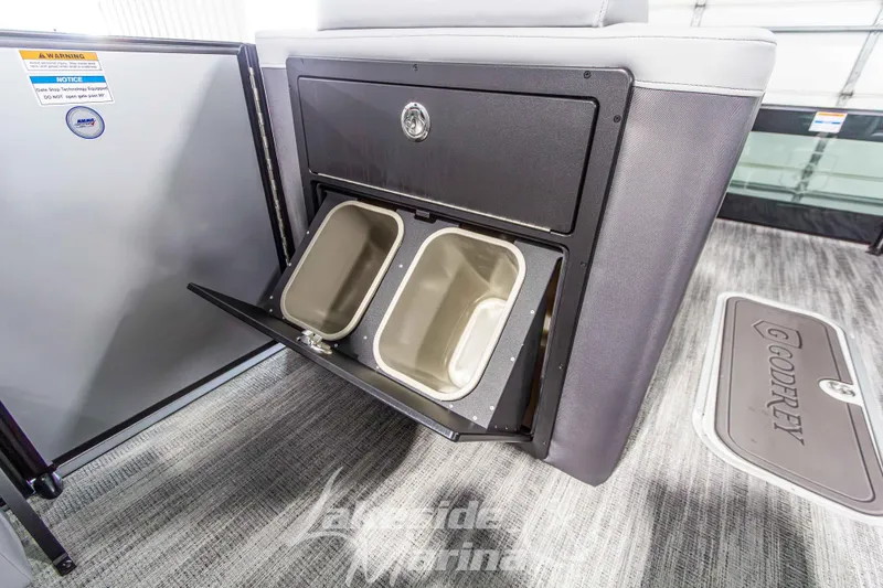 Slide: The Image of 2026 Godfrey Monaco 235 QSB boat interior with dual storage bins. - 24