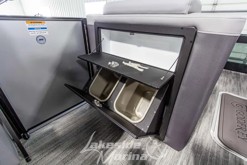 Slide: The Image of 2026 Godfrey Monaco 235 QSB boat interior storage compartment with open shelves. - 25