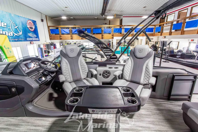 Slide: The Image of 2026 Godfrey Monaco 235 QSB boat interior with luxurious seating and modern dashboard. - 27