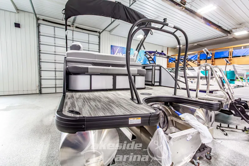 Slide: The Image of 2026 Godfrey Monaco 235 QSB pontoon boat in showroom, rear view with seating and ladder. - 4