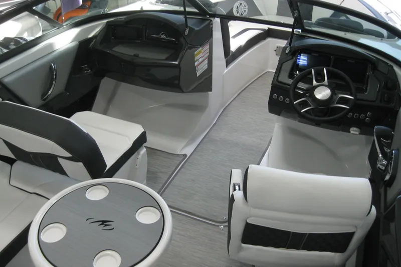 Slide: The Image of Interior of 2025 Monterey 238SS Super Sport boat with modern seating and steering wheel. - 6