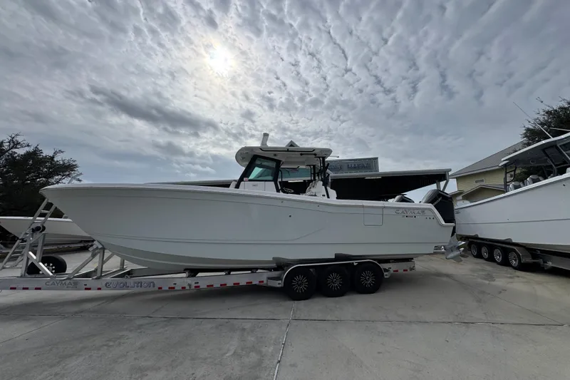 The Image of 2024 Caymas 34 CT boat on trailer under cloudy sky. - 1