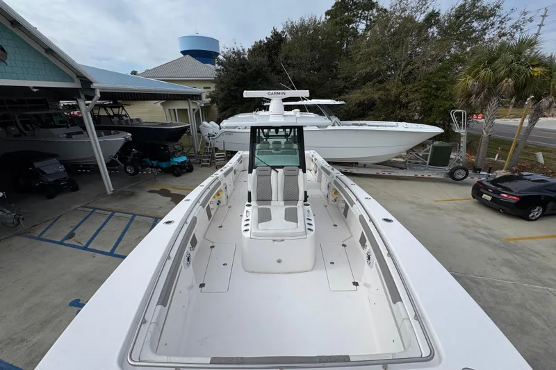 Slide: The Image of 2024 Caymas 34 CT boat in marina, showcasing spacious deck and modern design. - 20