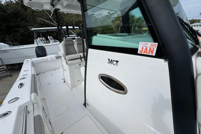 Slide: The Image of 2024 Caymas 34 CT boat with Alabama registration sticker, featuring spacious deck and seating. - 25