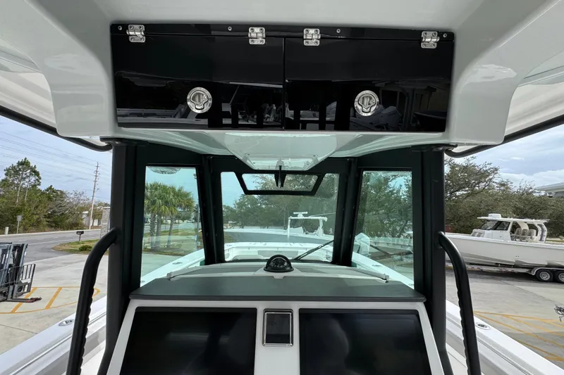 Slide: The Image of 2024 Caymas 34 CT boat helm with modern controls and overhead storage. - 32