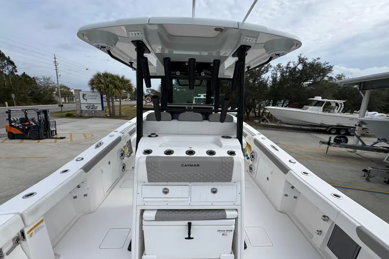 Slide: The Image of 2024 Caymas 34 CT boat interior with seating and storage, docked at a marina. - 37
