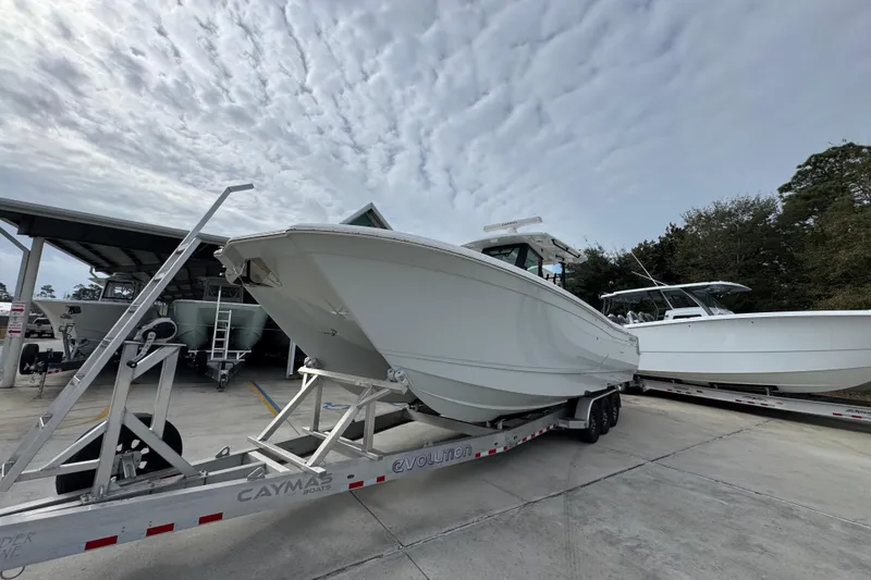 Slide: The Image of 2024 Caymas 34 CT boat on trailer under cloudy sky at marina. - 4